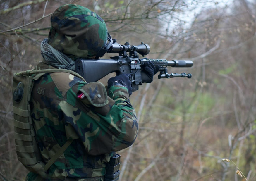 airsoft designated marksman using an airsoft scope to see target