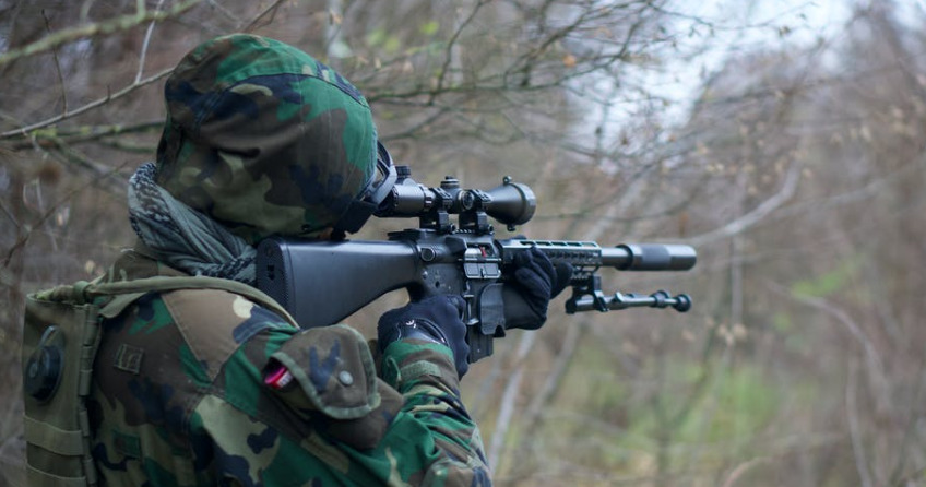 picture of airsoft player using DMR and shooting from range to avoid hurting his friends