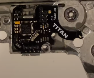 close up picture of a gate titan mosfet with binary trigger function set into an airsoft gearbox