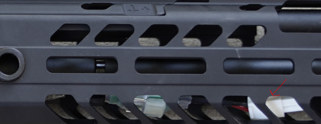 close up picture of sig sauer mcx airsoft gun showing front wiring under handguard and limited space