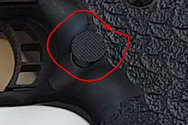close up picture of the sti combat master mag release showing size
