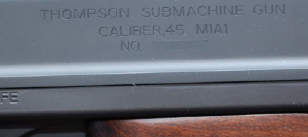 close up picture of trademarks found on authentic airsoft tommy gun